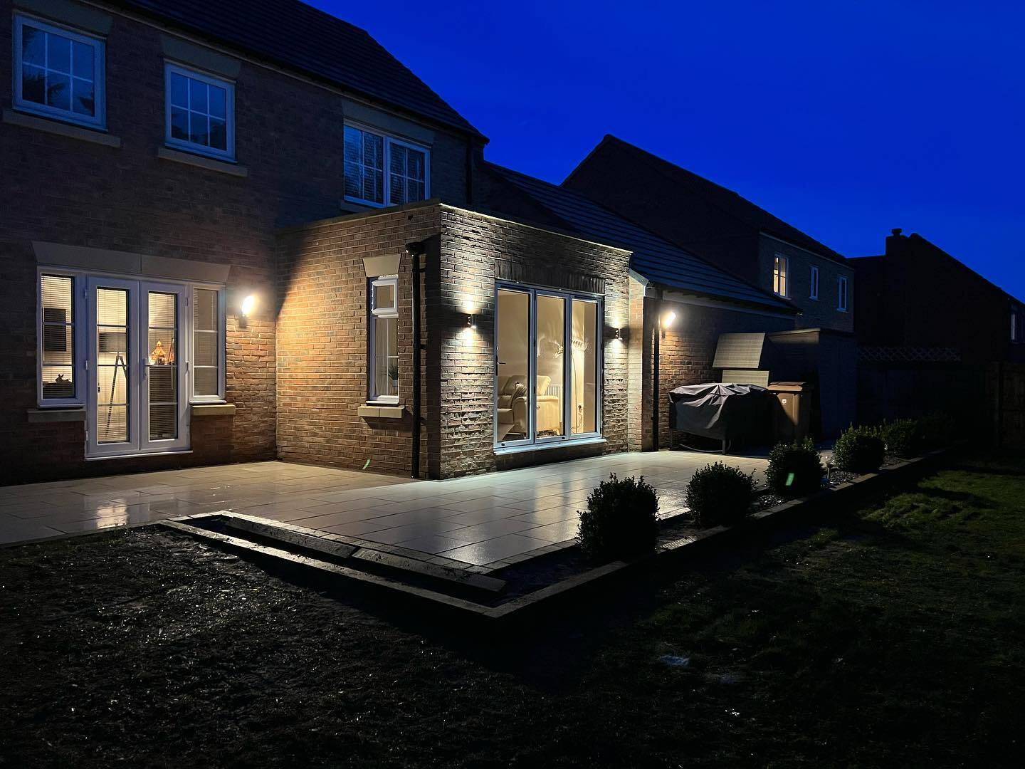 Modern single storey home extension with floor-to-ceiling windows and open-plan living space