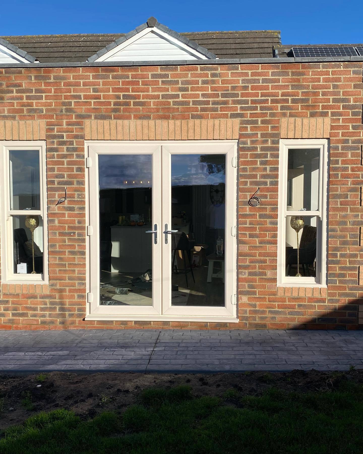 the outside of a house extension, taken in the daytime showcasing luxury external doors and windows